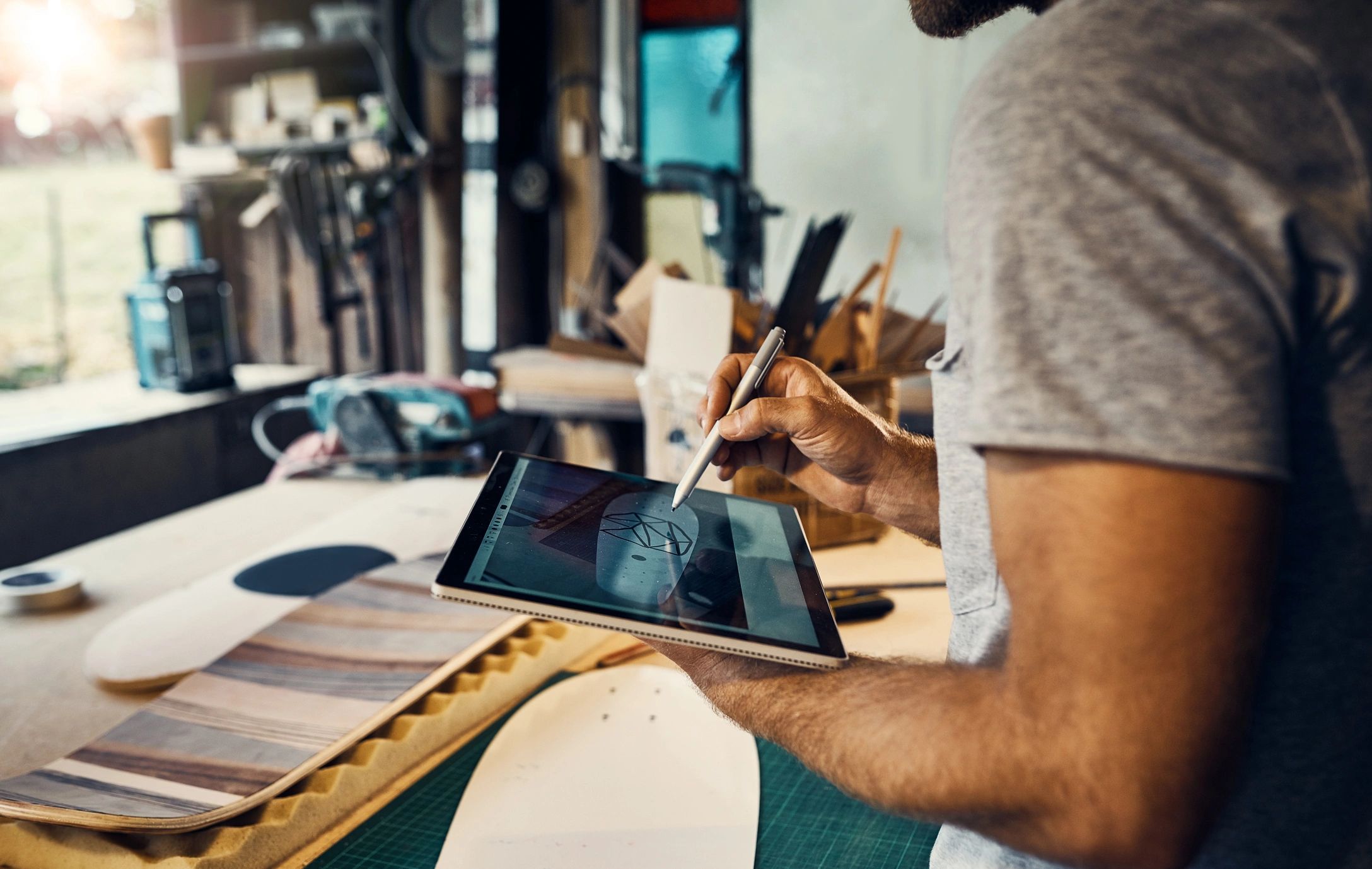 Designer preparing artwork on a tablet in a workshop